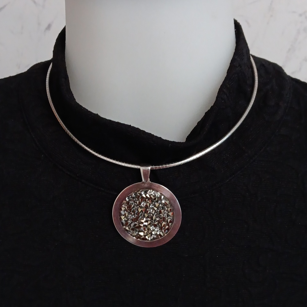 Sterling silver choker style necklace with pendant.